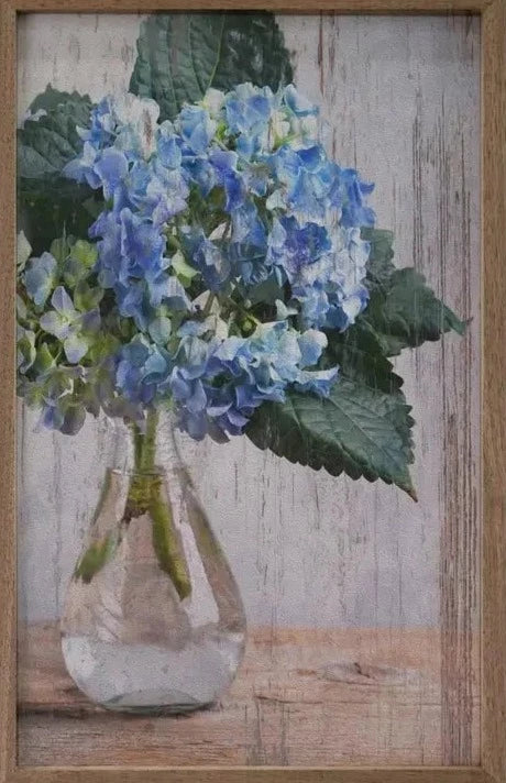 These hydrangeas are absolutely gorgeous and will make a statement wherever you put it!  Available in different sizes, you love the glass vase setting on the table with three blue hydrangeas in them!  It is made from high-quality American hardwood planks with a hand-painted face, printed with UV-cured ink, and framed in a natural walnut frame. Each piece is unique with its own personality, marks, wood grain, and look. Easy to clean with a dry cloth.  Made in the USA