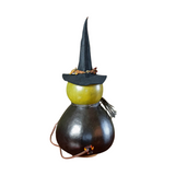 Fiona is our enchanting witch that is hand-crafted from hard shell gourds. She is hand-dyed green and black in color. expert crafters hand-cut her fun winking face, and her star and moon cutout. She has a handmade black felt witch hat and a handmade black clay nose. Fiona sits on a removable cork base to allow the design to be lit with a battery-operated tea light, or an orange colo

Warning: Gourds are flammable. Do not use candles in them or place them near open flames.

Made in the United States

Dimensi