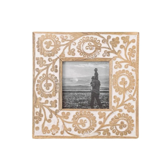 This beautiful carved floral mango wood picture frame holds a 4x4 photo and is the perfect addition to your home decor! Details of the intricately carved floral design are enhanced by a heavy whitewash, making the pattern on the frame border pop from the natural mango wood. 