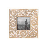 This beautiful carved floral mango wood picture frame holds a 4x4 photo and is the perfect addition to your home decor! Details of the intricately carved floral design are enhanced by a heavy whitewash, making the pattern on the frame border pop from the natural mango wood.&nbsp;