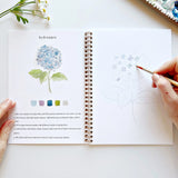 We are obsessed with this Flower Watercolor Workbook! It includes 12 floral illustrations with an example of the finished painting, step-by-step instructions, and a lightly illustrated sketch for you to paint. It's just like a coloring book, but with watercolor! Enjoy this peaceful painting hobby on your own, with children, or with friends. Makes a wonderful gift and is perfect for artists of any age.

12 beginner-friendly illustrations on thick 120lb watercolor paper

Lay-flat pages with spiral binding for