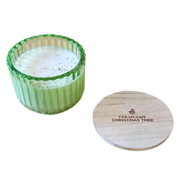 You'll love our new cathedral bowl candle style and size! This fresh cut Christmas tree candle has been poured into a pretty green glass bowl and comes with a wooden lid.

Take a trip back to your childhood of heading to town, ice skating, Christmas lights, and the beautiful pine smell of picking out your perfect tree! 

Filled with 6.5 oz. of American Soybean WaxTM. Measures 4.25