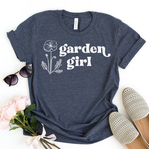 You are "our people!" We love working in our gardens - it is our favorite place to be - so grab yourself this navy Bell Canvas tee with a white outline of a flower on the left hand side and "garden girl" in a white font to the right of it. You'll love how soft this t-shirt is - you'll have it on all summer long!

Printed on a Bella Canvas T-shirt. Made in the USA