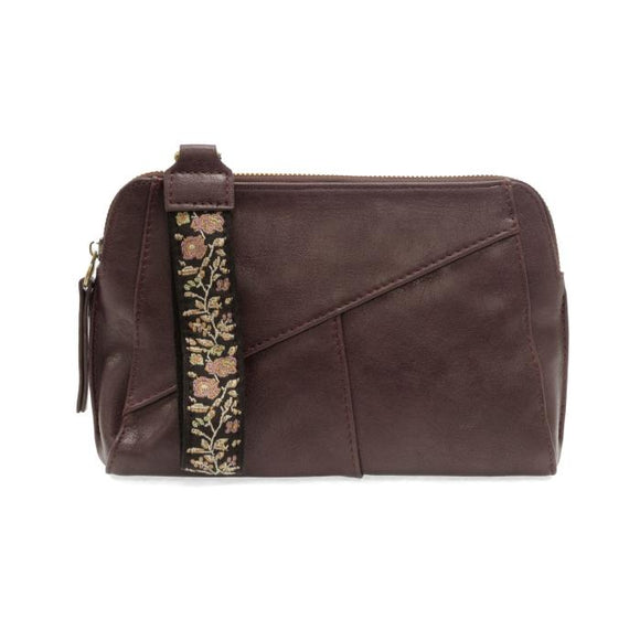 Retro styling crafted in antiqued vegan leather gives this beautiful dark plum colored clutch a vintage vibe. The removable woven wrist strap is the finishing touch on this stylish bag so that you can wear it as a wristlet, a clutch, or even a crossbody with the included removable shoulder strap!      6.75