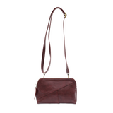 Retro styling crafted in antiqued vegan leather gives this beauitful currant colored clutch a vintage vibe. The removable woven wrist strap is the finishing touch on this stylish bag, so you can wear as a wristlet, a clutch, or even a crossbody with the included removable shoulder strap!





6.75"H x 9.75"W x 2.25"D

Removable and adjustable crossbody strap 22"-26"

Removable long wristlet strap 7.5" long

Zippered top closure

Interior zippered pocket

Exterior back zipper pocket

Brass plated hardware

1