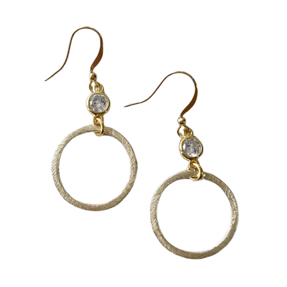 These earrings will give your outfit a trendy flair this weekend!  Gold brushed circular hoops topped with a sparkle with a circular crystal gem at the top of the hoop.

1 1/2” long