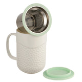 This 15oz Coral design tea infuser mug is made from new bone china and has a mint green silicone top. The exterior of the tea infuser mug features a coral-textured design. The top part of the mug where you drink is a smooth finish. The mug's interior is white, allowing you to see the color of the tea. The mug includes a stainless steel filter for loose-leaf tea and tea bags. The mug has a comfortable handle and a nice weight and feel. It is not too heavy. The handle does not get hot in the microwave.&nbsp;