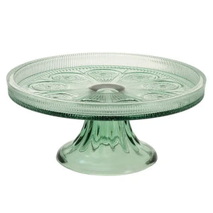This pretty green glass cake stand is a nod to times gone by! It's a beautifully crafted stand with an intricate raised pattern that adds a touch of sophistication to any table setting.&nbsp;

8.25" Dia x 3.5" H

Hand wash only, not dishwasher safe, not microwave safe.