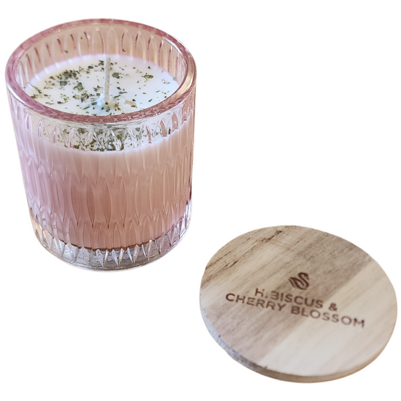 You'll love our newest cathedral glass tumbler! This hibiscus & cherry blossom candle has been poured into a pretty pink patterned glass and comes with a wooden lid.

Delicate and complex - a sensual musk fruity-floral blend! Cashmere undertones of musk and sandalwood balance white floral notes of jasmine. Sweet yet tart notes of red hibiscus amplify black cherry and coconut water to create a lush and unique fragrance experience.


Filled with 6.5 oz. of American Soybean WaxTM. Measures 3.25
