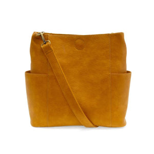 Casual and carefree crossbody in super soft pebble grain vegan leather! Our Kayleigh bucket bag is in a beautiful honey color and comes with a smaller bag that can be carried inside or used alone! The convenient side pockets of this bucket bag can hold your water bottle, phone, or glasses.&nbsp;     11" W X 11.25" H X 3.5"