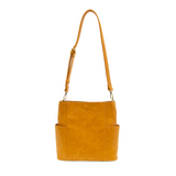 Casual and carefree crossbody in super soft pebble grain vegan leather! Our Kayleigh bucket bag is in a beautiful honey color and comes with a smaller bag that can be carried inside or used alone! The convenient side pockets of this bucket bag can hold your water bottle, phone, or glasses.&nbsp;     11" W X 11.25" H X 3.5"