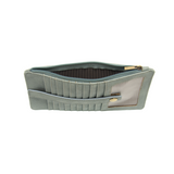 This slim and sleek wallet has nine credit card pockets, each with a snap tab for security and brass-plated hardware. It also has an ID window, zippered change pocket, and zippered billfold pocket in distressed bluebird skies vegan leather.


DIMENSIONS: 3.75 IN. H X 7.25 IN. W X .25 IN. D&nbsp;


100% Vegan leather (polyurethane)
