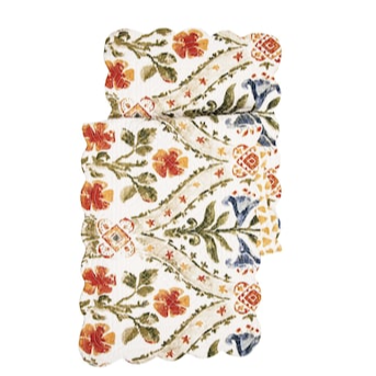 Freshen up your house with our new bohemian floral runner! With a bright white background and pretty blues. red-orange, yellows, and greens will brighten up any space.  Flip it over and the backside has yellow triangles scattered over it. Finished with a scalloped edge, this tabletop collection is crafted of 100% cotton and hand-guided machine quilting. 