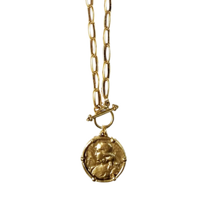 Oh, how we love&nbsp;our&nbsp;Joan of Arc&nbsp;Necklace! This cool gold coin necklace has a toggle in the front for easy on and off.

Necklace 18"

Pendant approx. 1-1/8"w