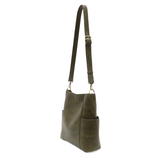 Green leather handbag with a strap on a white background