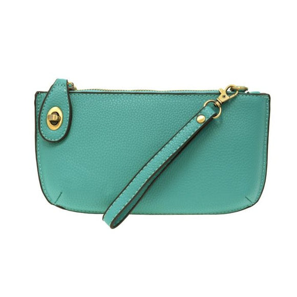 Our most popular bag, in a vibrant Mayan Green! With its sleek silhouette, this mini clutch is as gorgeous as it is versatile.  Features include a polished turn lock, six card slots, and an interior zipper for change.  It can be styled in many ways, with removable straps for alternating between wallet, crossbody, and wristlet!   5
