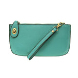 Our most popular bag, in a vibrant Mayan Green! With its sleek silhouette, this mini clutch is as gorgeous as it is versatile.  Features include a polished turn lock, six card slots, and an interior zipper for change.  It can be styled in many ways, with removable straps for alternating between wallet, crossbody, and wristlet!   5"H x 9.5"W x 1"D  Removable and adjustable crossbody strap 13"-24"  Wristlet strap 7" long