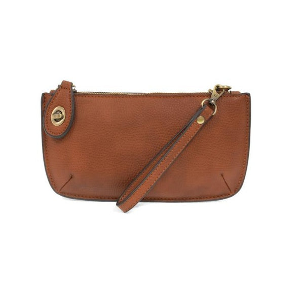 Our most popular bag, in a rich dark maple color, this mini clutch, with its sleek silhouette, is as gorgeous as it is versatile.  Features include a polished turn lock, six card slots, and an interior zipper for change.  It can be styled in many ways, with removable straps for alternating between wallet, crossbody, and wristlet!   5