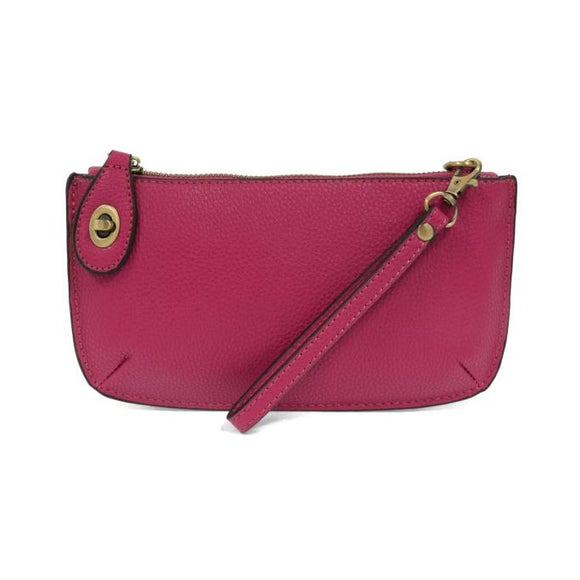 Our most popular bag, in a vibrant fuchsia! With its sleek silhouette, this mini clutch is as gorgeous as it is versatile.  Features include a polished turn lock, six card slots, and an interior zipper for change.  It can be styled in many ways, with removable straps for alternating between wallet, crossbody, and wristlet!   5