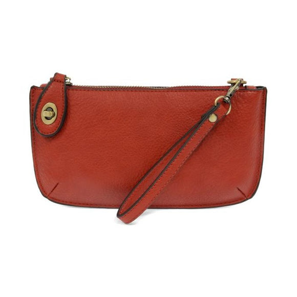 Our most popular bag, in a vibrant cherry red! With its sleek silhouette, this mini clutch is as gorgeous as it is versatile.  Features include a polished turn lock, six card slots, and an interior zipper for change.  It can be styled in many ways, with removable straps for alternating between wallet, crossbody, and wristlet!   5