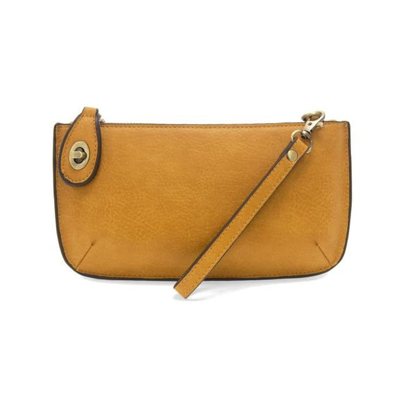 Our most popular bag, in a honey gold color, this mini clutch, with its sleek silhouette, is as gorgeous as it is versatile.  Features include a polished turn lock, six card slots, and an interior zipper for change.  It can be styled in many ways, with removable straps for alternating between wallet, crossbody and wristlet!   5
