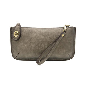 Our most popular bag, in metallic dark chrome color, this mini clutch, with its sleek silhouette, is as gorgeous as it is versatile.  Features include a polished turn lock, six card slots, and an interior zipper for change.  It can be styled in many ways, with removable straps for alternating between wallet, crossbody, and wristlet!   5"H x 9.5"W x 1"D  Removable and adjustable crossbody strap 13"-24"  Wristlet strap 7" long  interior zippered pocket  brass plated hardware  100% vegan leather (polyurethane)