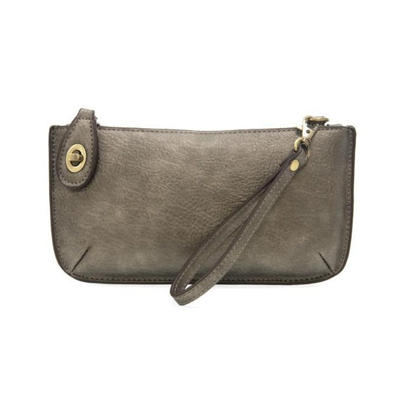 Our most popular bag, in metallic dark chrome color, this mini clutch, with its sleek silhouette, is as gorgeous as it is versatile.  Features include a polished turn lock, six card slots, and an interior zipper for change.  It can be styled in many ways, with removable straps for alternating between wallet, crossbody, and wristlet!   5