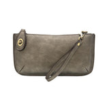 Our most popular bag, in metallic dark chrome color, this mini clutch, with its sleek silhouette, is as gorgeous as it is versatile.  Features include a polished turn lock, six card slots, and an interior zipper for change.  It can be styled in many ways, with removable straps for alternating between wallet, crossbody, and wristlet!   5"H x 9.5"W x 1"D  Removable and adjustable crossbody strap 13"-24"  Wristlet strap 7" long  interior zippered pocket  brass plated hardware  100% vegan leather (polyurethane)