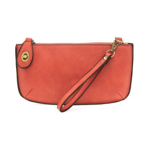 Our most popular bag, in a vibrant desert coral color! With its sleek silhouette, this mini clutch is as gorgeous as it is versatile.  Features include a polished turn lock, six card slots, and an interior zipper for change.  It can be styled in many ways, with removable straps for alternating between wallet, crossbody, and wristlet!   5"H x 9.5"W x 1"D  Removable and adjustable crossbody strap 13"-24"  Wristlet strap 7" long