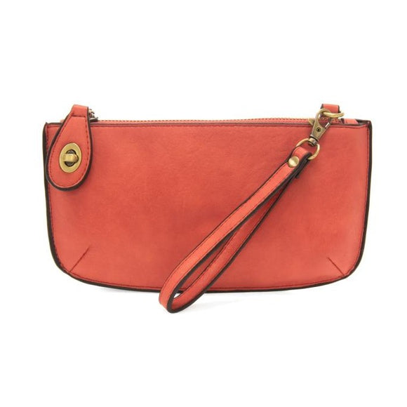 Our most popular bag, in a vibrant desert coral color! With its sleek silhouette, this mini clutch is as gorgeous as it is versatile.  Features include a polished turn lock, six card slots, and an interior zipper for change.  It can be styled in many ways, with removable straps for alternating between wallet, crossbody, and wristlet!   5