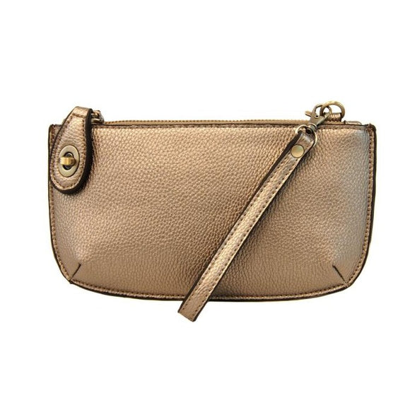 Our most popular bag, in a beautiful metallic light bronze, this mini clutch, with its sleek silhouette, is as gorgeous as it is versatile.  Features include a polished turn lock, six card slots, and an interior zipper for change.  It can be styled in many ways, with removable straps for alternating between wallet, crossbody, and wristlet!   5