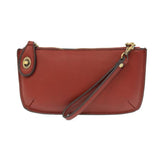 Our most popular bag, in a rich garnet color, this mini clutch, with its sleek silhouette, is as gorgeous as it is versatile.  Features include a polished turn lock, six card slots, and an interior zipper for change.  It can be styled in many ways, with removable straps for alternating between wallet, crossbody, and wristlet!   5"H x 9.5"W x 1"D  Removable and adjustable crossbody strap 13"-24"  Wristlet strap 7" long  interior zippered pocket  brass plated hardware  100% vegan leather (polyurethane)