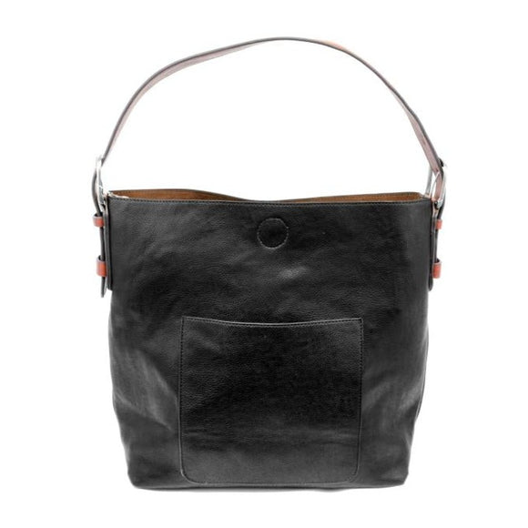 Equally timeless and modern, our best-selling classic hobo is made in rich vegan leather in a beautiful black, accented with a brown strap.  This roomy bag, accented with a large front pocket and a snap-in removable brown crossbody, has plenty of room to carry your needs in style.