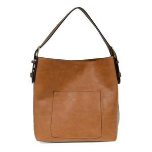 Equally timeless and modern, our best-selling classic hobo is made in rich vegan leather in a beautiful hazelnut color, accented with a dark brown strap.  This roomy bag, accented with a large front pocket and a snap-in removable brown crossbody, has plenty of room to carry your needs in style.