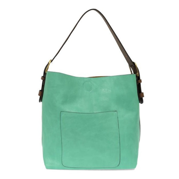 Equally timeless and modern, our best-selling classic hobo is made in rich vegan leather in a beautiful seafoam color, accented with a coffee brown strap.  This roomy bag, accented with a large front pocket and a snap-in removable brown crossbody, has plenty of room to carry your needs in style. MAIN BAG 12