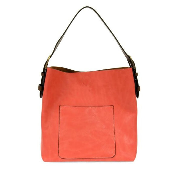 Equally timeless and modern, our best-selling classic hobo is made in rich vegan leather in a beautiful hot coral color, accented with a coffee brown strap.  This roomy bag, accented with a large front pocket and a snap-in removable brown crossbody, has plenty of room to carry your needs in style. MAIN BAG 12