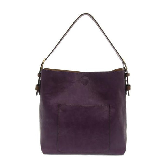 Equally timeless and modern, our best-selling classic hobo is made in rich vegan leather in a fun Purplicious color, accented with a coffee brown strap.  This roomy bag, accented with a large front pocket and a snap-in removable brown crossbody, has plenty of room to carry your needs in style.