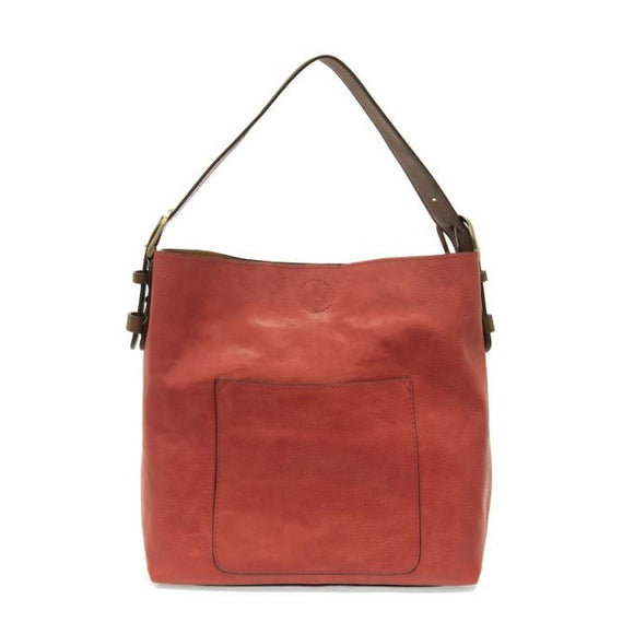 Equally timeless and modern, our best-selling classic hobo is made in rich vegan leather in a beautiful deep berry color, accented with a brown strap.  This roomy bag, accented with a large front pocket and a snap-in removable brown crossbody, has plenty of room to carry your needs in style.