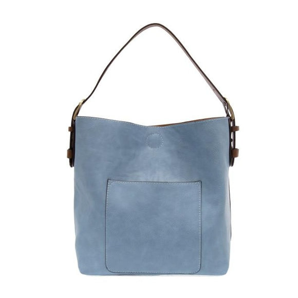 Equally timeless and modern, our best-selling classic hobo is made in rich vegan leather in a beautiful tranquil blue color, accented with a coffee brown strap.  This roomy bag, accented with a large front pocket and a snap-in removable brown crossbody, has plenty of room to carry your needs in style. MAIN BAG 12