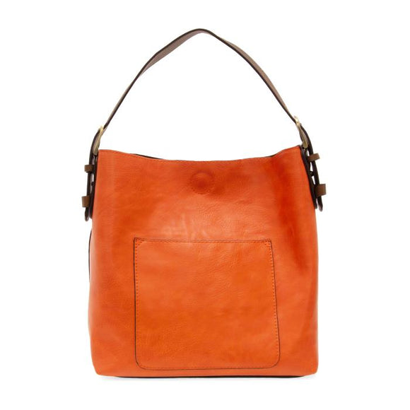 Equally timeless and modern, our best-selling classic hobo is made in rich vegan leather in a beautiful clementine orange color, accented with a brown strap.  This roomy bag, accented with a large front pocket and a snap-in removable brown crossbody, has plenty of room to carry your needs in style.


MAIN BAG

12