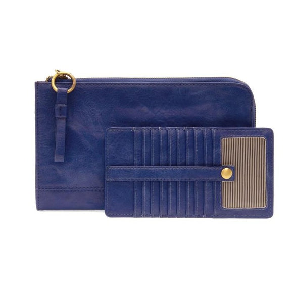 The Karina combines sleek styling with uber organization in beautiful antique-looking  Monaco blue vegan leather! This bag has the ultimate versatility, as it can be worn as a crossbody, a clutch, or a wristlet. The included bonus wallet with credit card slots, ID windows, zippered change pocket, and billfold will keep you organized on the go and can be carried separately!