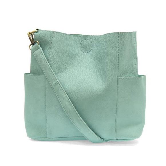Casual and carefree crossbody in super soft pebble grain vegan leather! Our Kayleigh bucket bag is in a beautiful aquamarine color and comes with a smaller bag that can be carried inside or used alone! The convenient side pockets of this bucket bag can carry your water bottle, phone, or glasses.    11