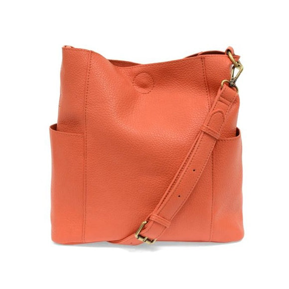 Casual and carefree crossbody in super soft pebble grain vegan leather! Our Kayleigh bucket bag in a bright grapefruit color comes with a smaller bag that can be carried inside or used alone! The convenient side pockets of this bucket bag can carry your water bottle, phone, or glasses.  11