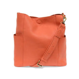 Casual and carefree crossbody in super soft pebble grain vegan leather! Our Kayleigh bucket bag in a bright grapefruit color comes with a smaller bag that can be carried inside or used alone! The convenient side pockets of this bucket bag can carry your water bottle, phone, or glasses.  11" W X 11.25" H X 3.5" Magnetic Snap Closure