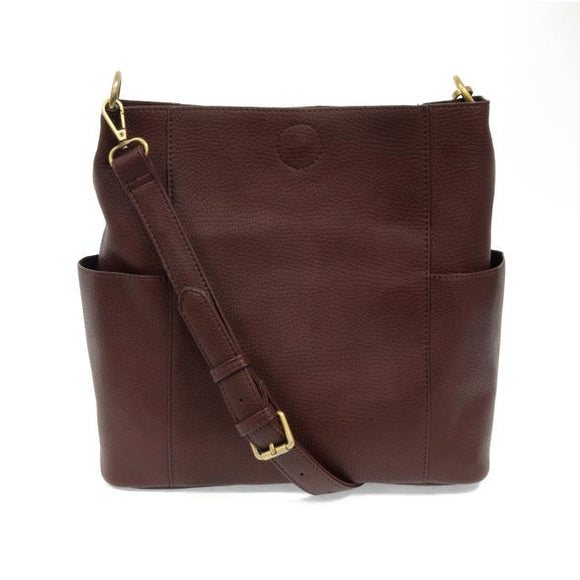Casual and carefree crossbody in super soft pebble grain vegan leather! The convenient side pockets carry your water bottle, phone or glasses.  11