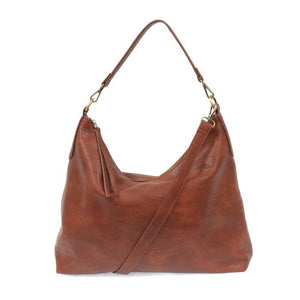 This oversized, slouchy, cool hobo bag is made of tumbled buffalo grain cinnamon-colored vegan leather, which gives it that casual boho chic look! With two included removable shoulder straps, you can wear it as a short shoulder bag or a crossbody bag.