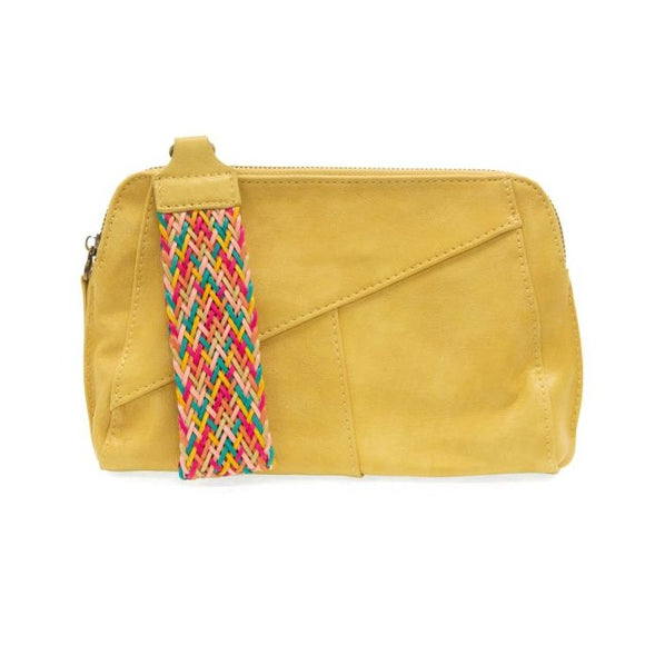 Retro styling crafted in antiqued vegan leather gives this awesome mellow yellow clutch a vintage vibe. The removable woven wrist strap is the finishing touch on this stylish bag, so you can wear it as a wristlet, a clutch, or a crossbody with the removable shoulder strap included!      6.75