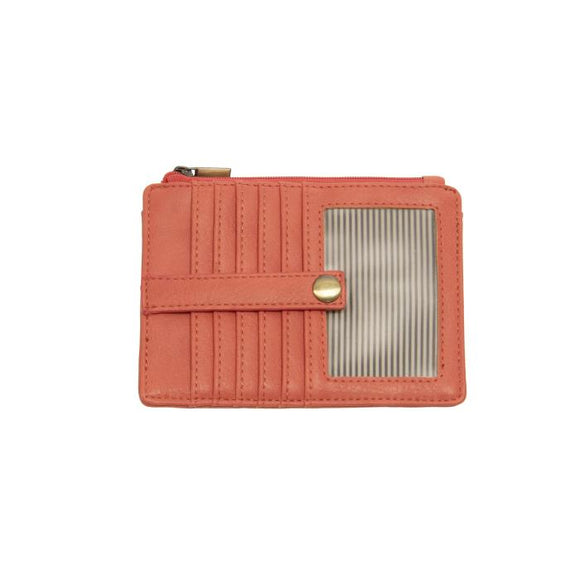 We love this mini wallet in a happy living coral colored vegan leather! It is full of style and will hold your license and up to six credit cards. The zipper pocket is roomy enough for your change and cash, and a pocket is on the back.  This mini wallet is perfect for you, but it makes an awesome gift!  DIMENSIONS: 4 IN. H X 5.5 IN. W X .25 IN. D  ZIPPERED TOP CLOSURE ON EDGE  6 CREDIT CARD POCKETS  ID WINDOW POCKET