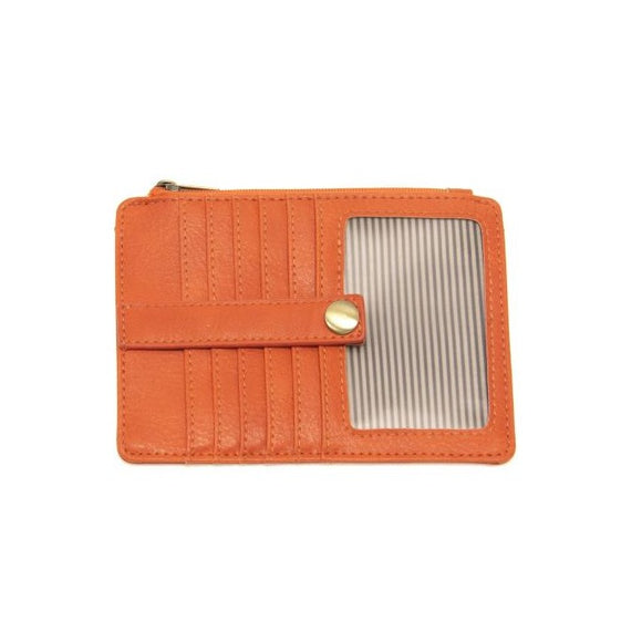 We love this mini wallet in a bright and cheerful clementine colored vegan leather! It is full of style and will hold your license and up to six credit cards. The zipper pocket is roomy enough for your change and cash, and a pocket is on the back.  This mini wallet is perfect for you, but it makes an awesome gift!  DIMENSIONS: 4 IN. H X 5.5 IN. W X .25 IN. D  ZIPPERED TOP CLOSURE ON EDGE  6 CREDIT CARD POCKETS  ID WINDOW POCKET