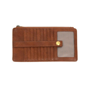 This slim and sleek wallet has nine credit card pockets, each with a snap tab for security and brass-plated hardware. It also has an ID window, zippered change pocket, and zippered billfold pocket in distressed saddle brown vegan leather.


DIMENSIONS: 3.75 IN. H X 7.25 IN. W X .25 IN. D&nbsp;